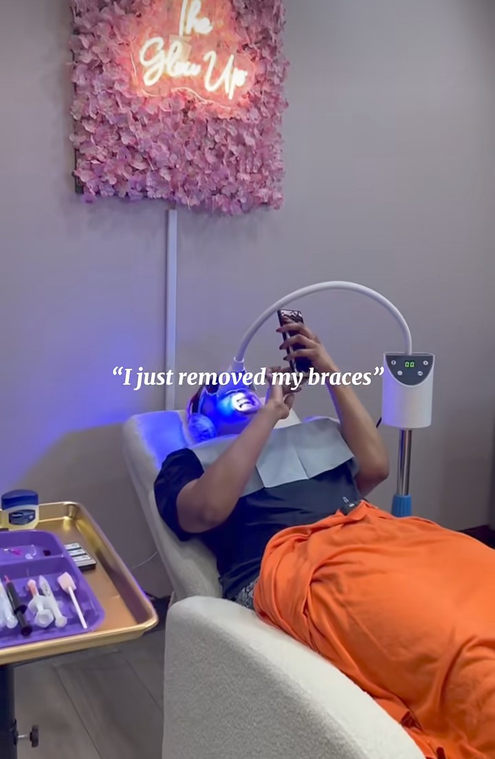 Client relaxing under the LED whitening lamp at the Sophisticated Glow studio
